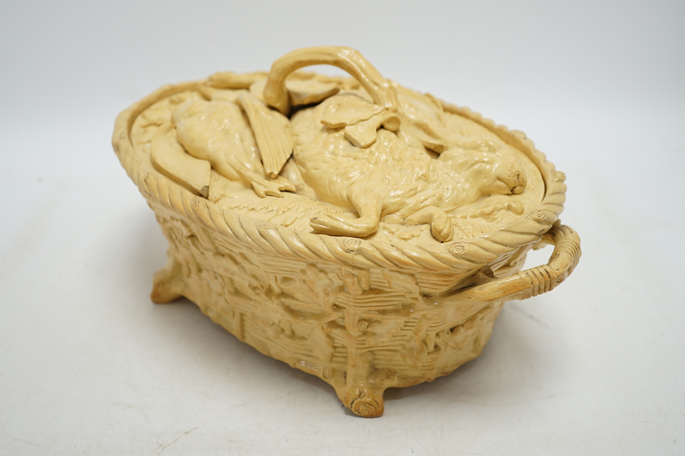 A 19th century Minton caneware game pie dish and cover, 33cm wide. Condition - acorn leaf tip and wing tip missing on cover, small chips to inner lip of tureen.